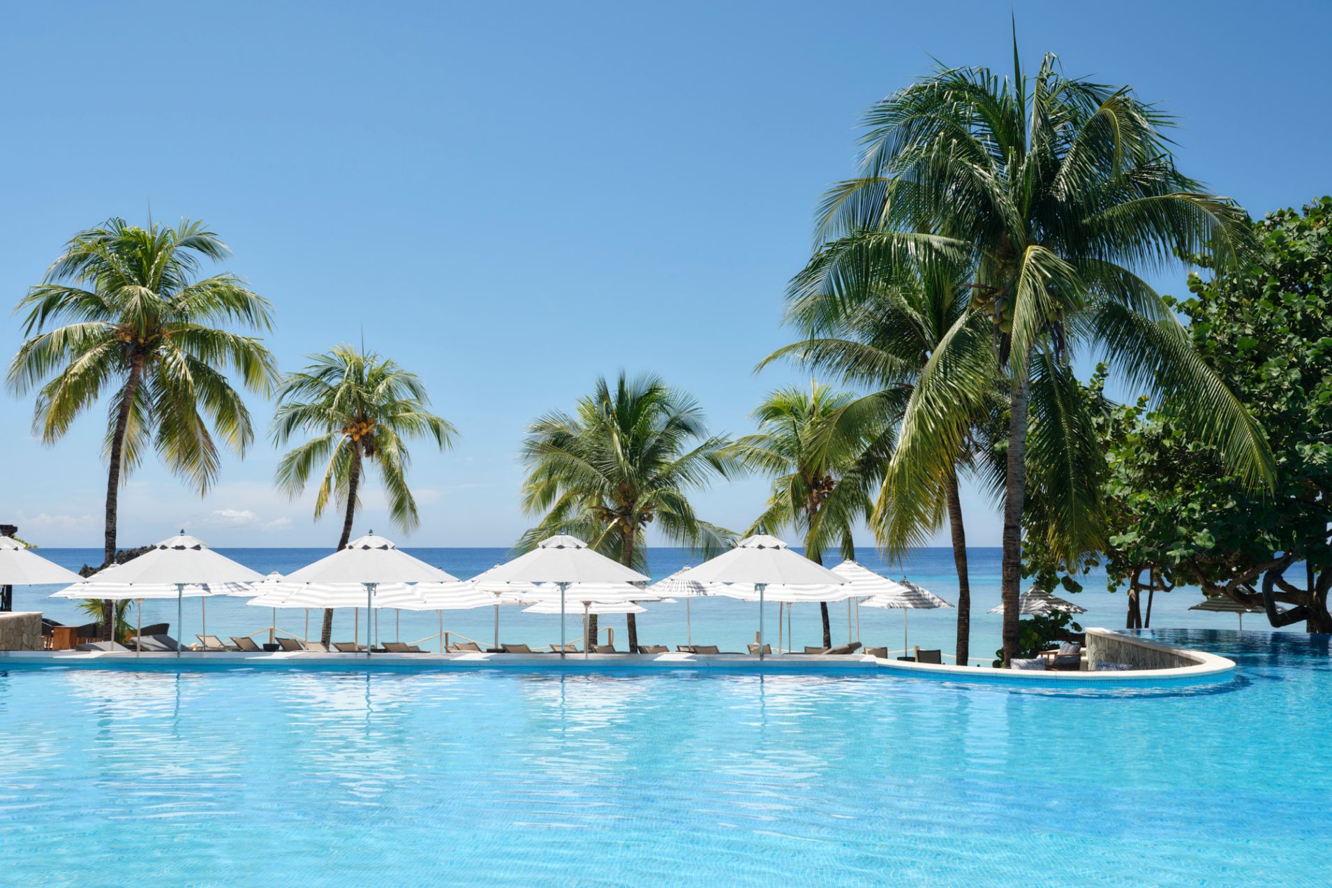 serene pool with views of lush island foliage and endless blue sea