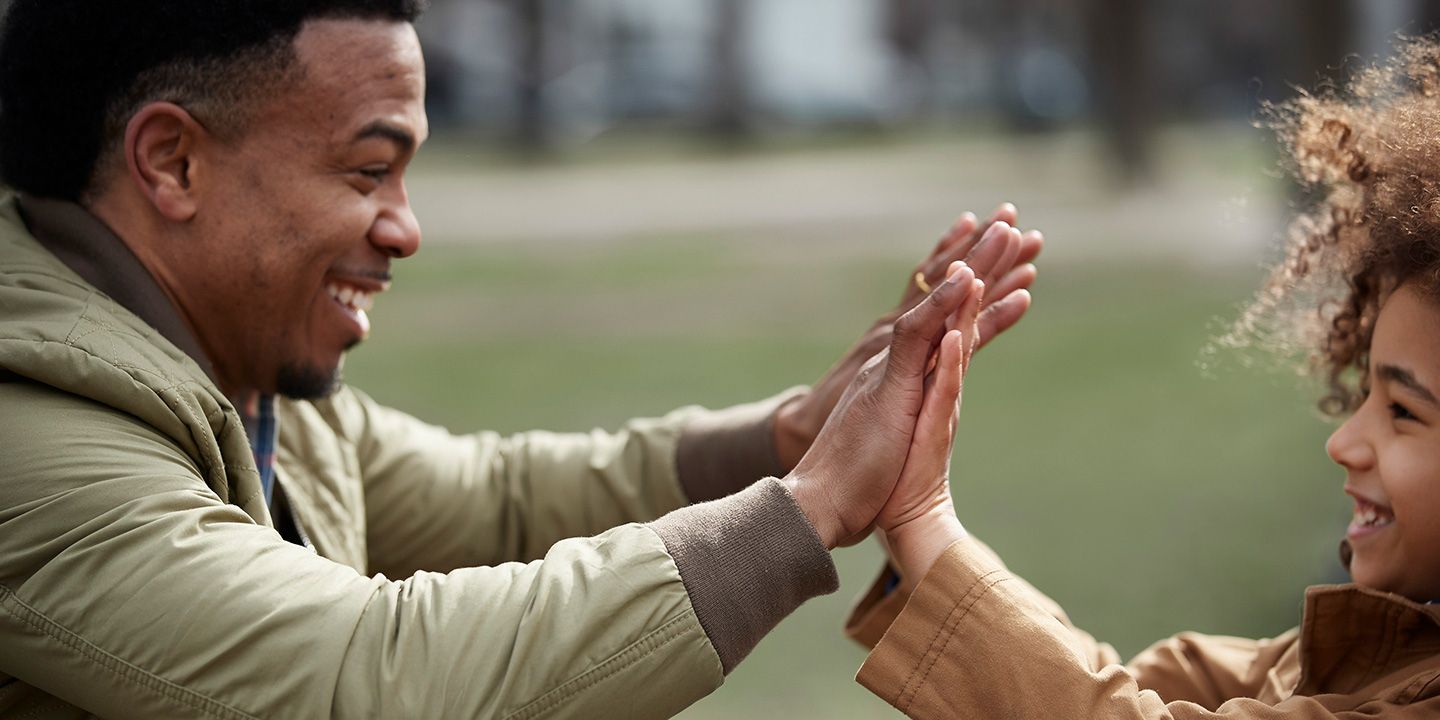 Father clapping hands together with child