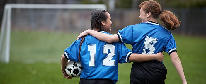 Soccer girls hugging