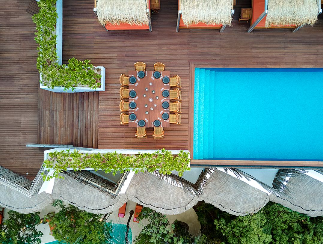 overhead view of rooftop pool deck and cabanas