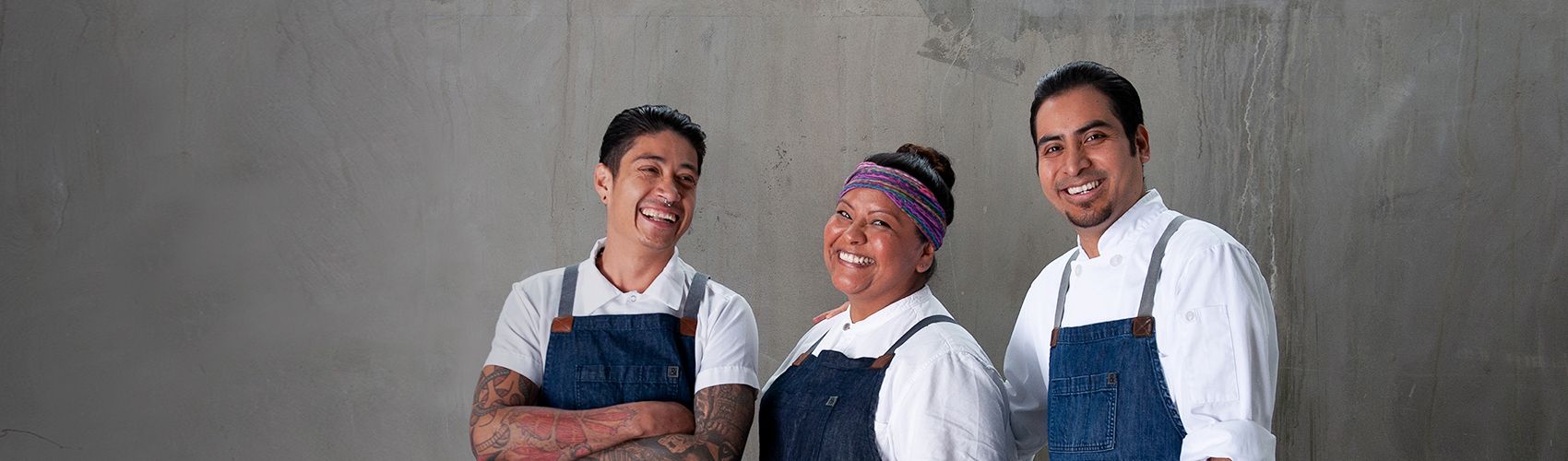 Three staff members smiling