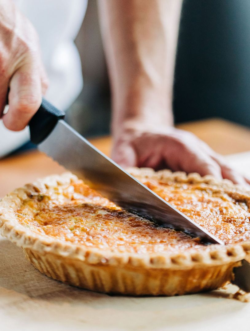 festive pie with a person cutting a slice