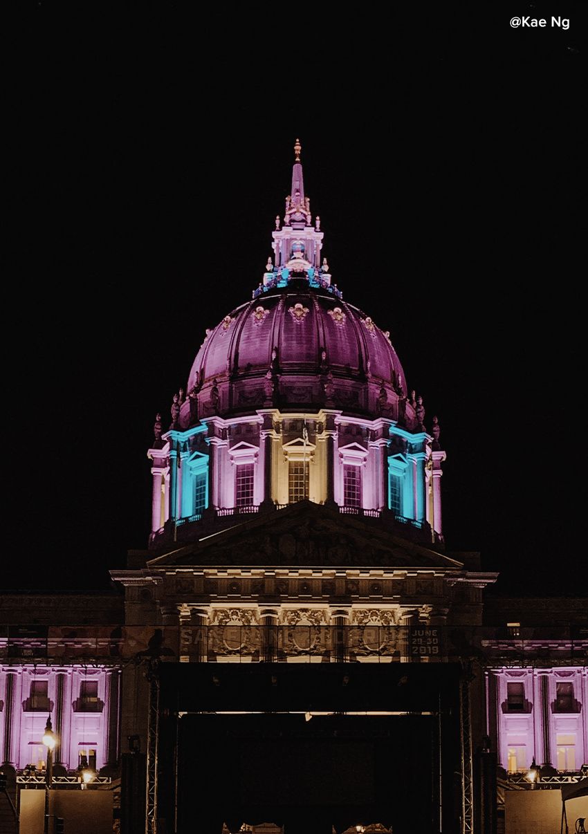 Night view of the city capitol lit up in a rainbow of lights.