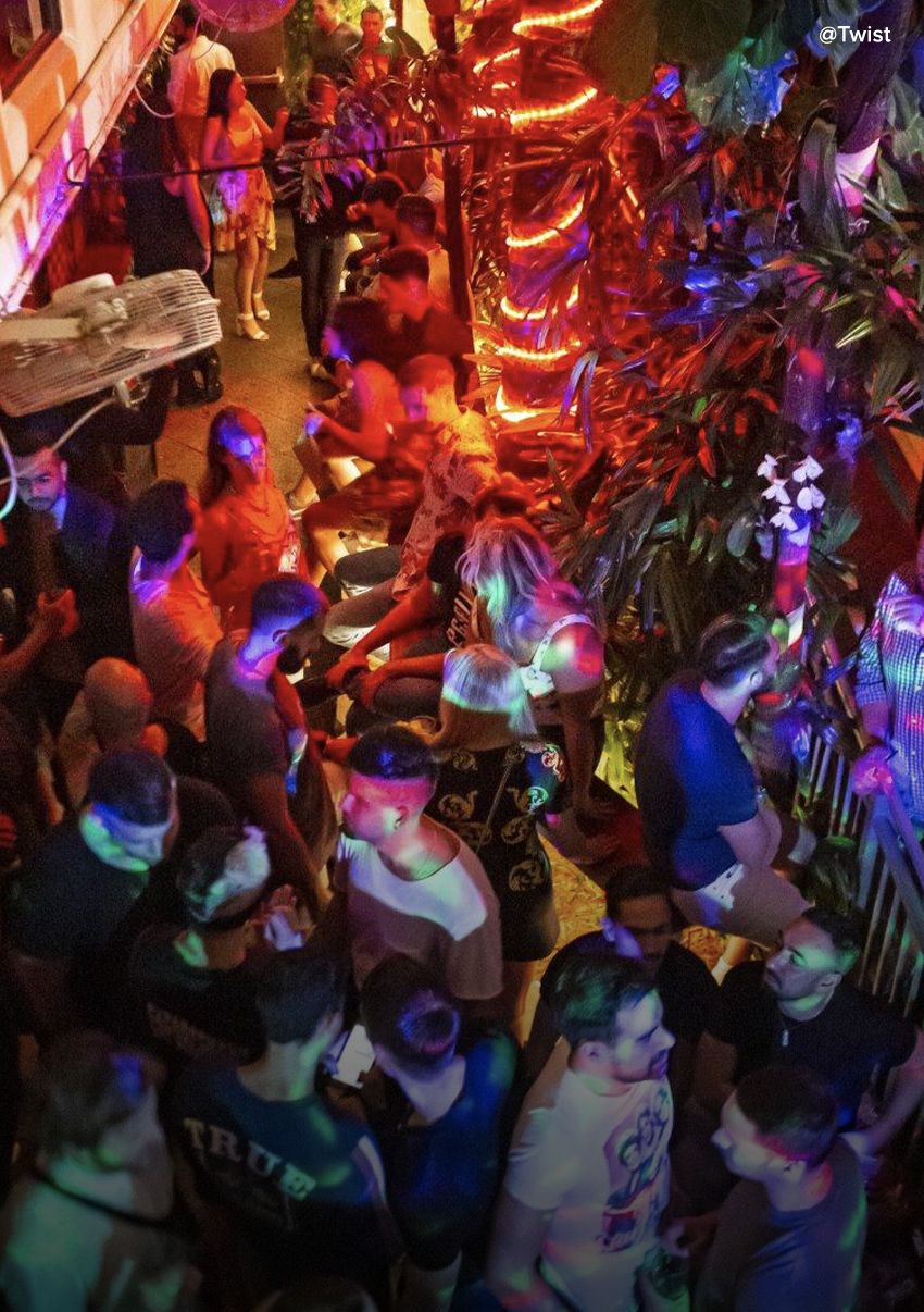 Overhead view of a party packed with people outside at night.