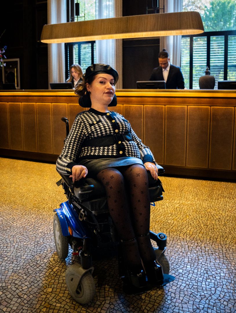 fashionable woman in a wheelchair in glamourous london hotel lobby