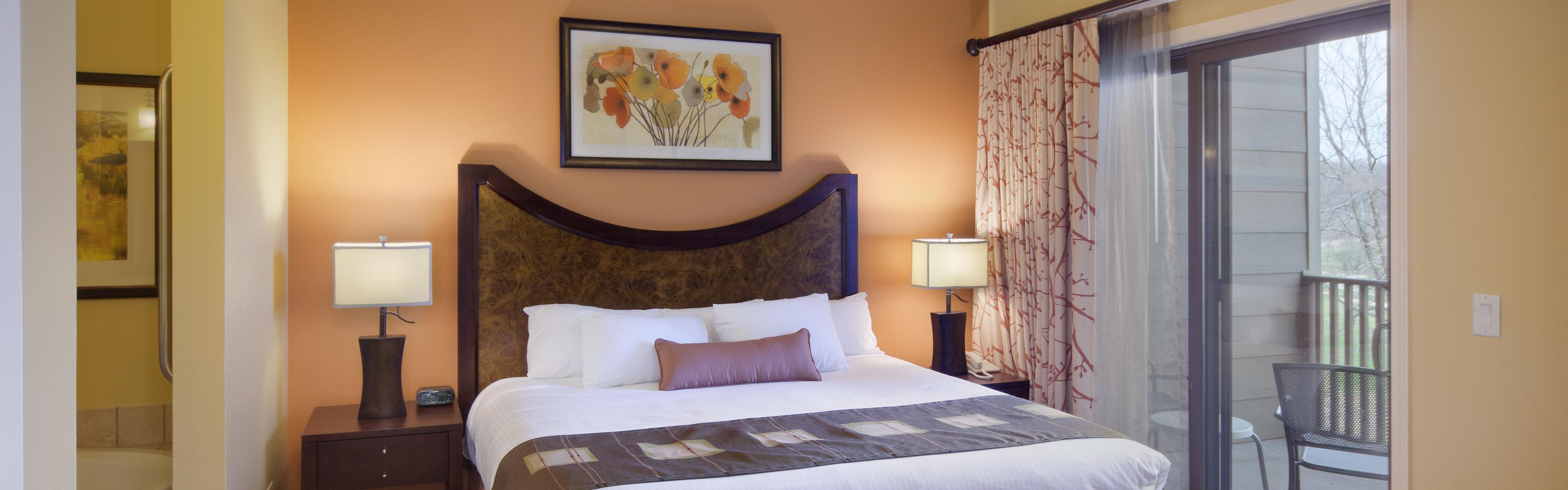 bedroom with bed, art, and balcony, where to stay in lake geneva, WI 