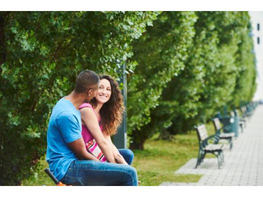 Couple at a park looking at each other