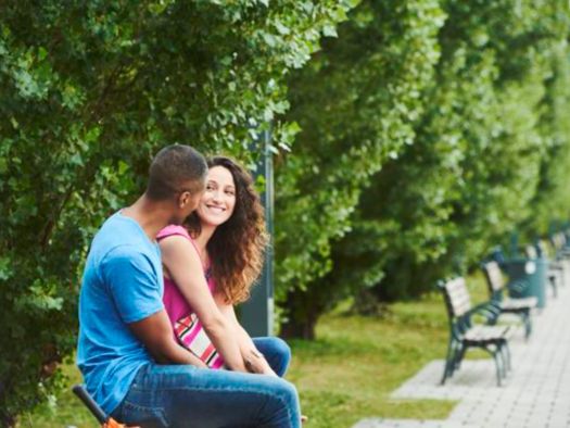 Couple sitting on a bench in a park