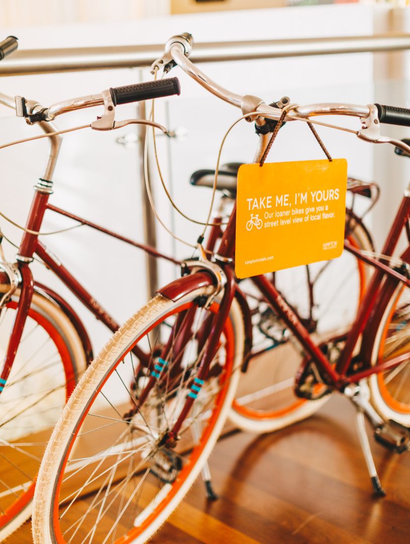 orange and red bikes in a sunny lobby