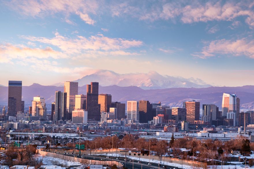 View of Denver cityscape in the winter backed by mountains
