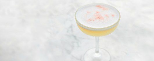 Bàn đá cẩm thạch trắng với ly cocktail màu trắng, hồng và vàng xinh xắn