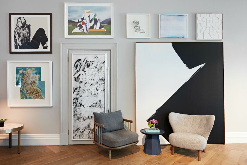 A chair sitting in front of a wall of art