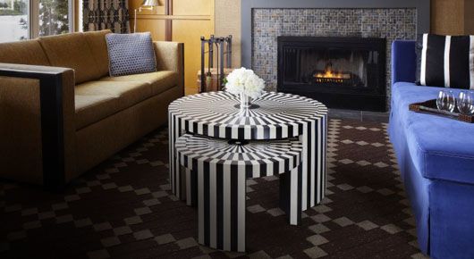 Black and white striped stacking coffee table with a brown couch and a blue couch