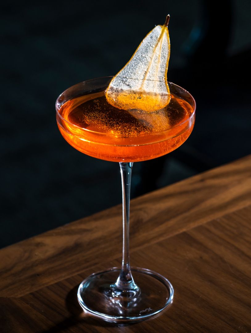 beautiful cocktail with sliced pear garnish