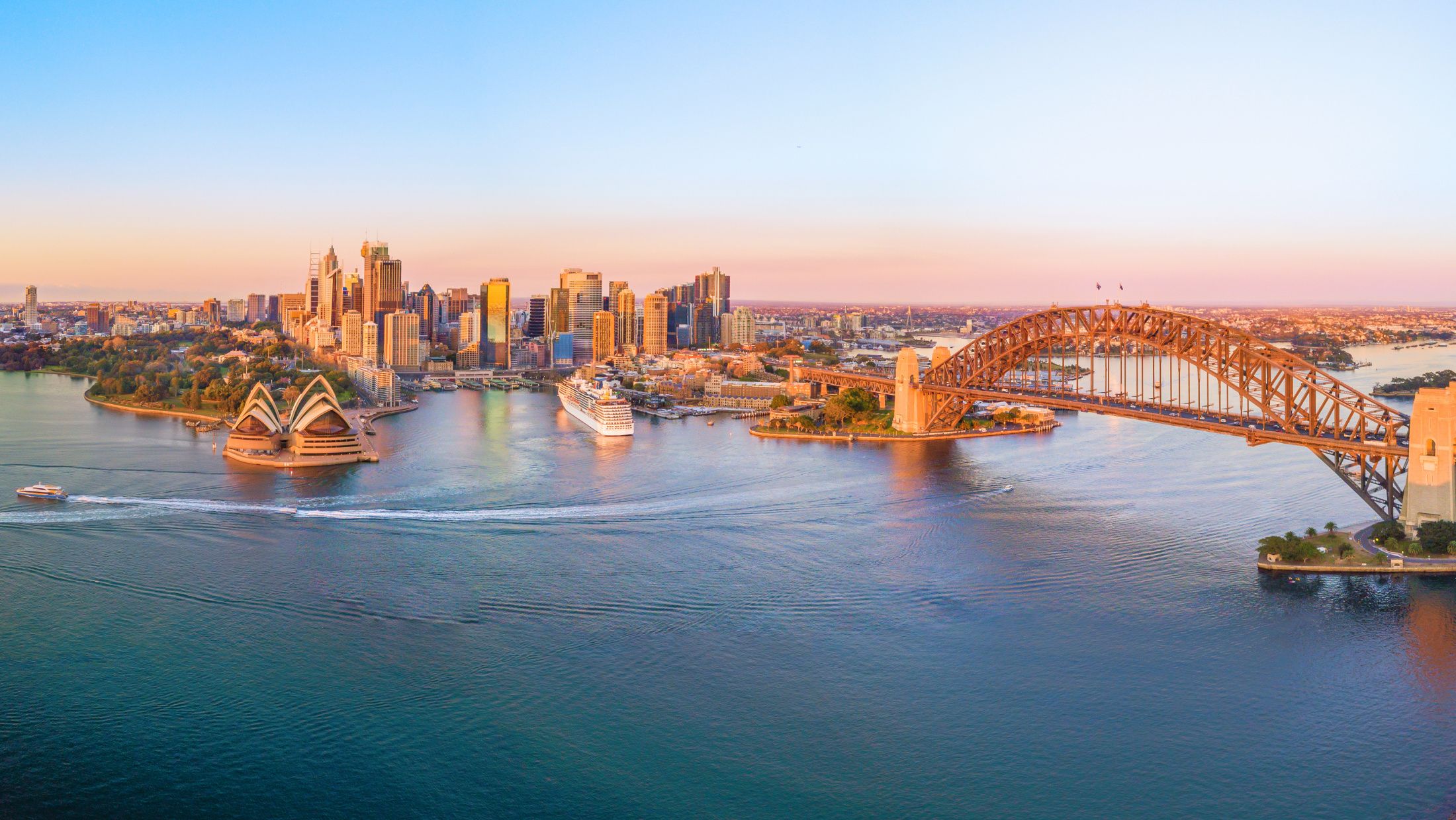 aerial view of the city, bridge and famous opera house in sydney