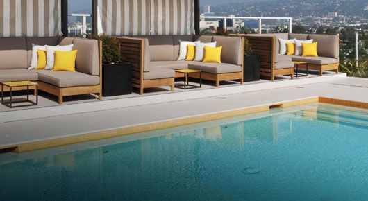 Pool side view with covered tan and yellow sectionals