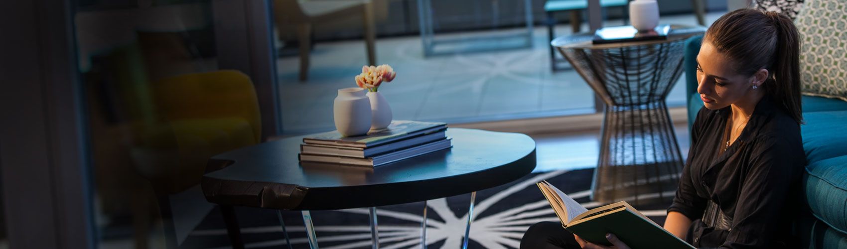 Woman sitting in chair reading a book